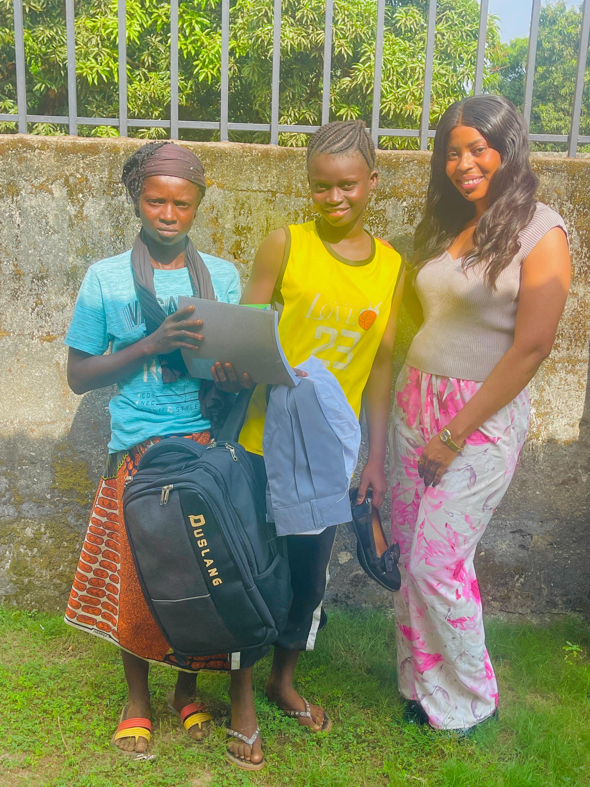sata M Bangura, a One Girl scholar, returning to Yoninana Secondary School with her new school materials.